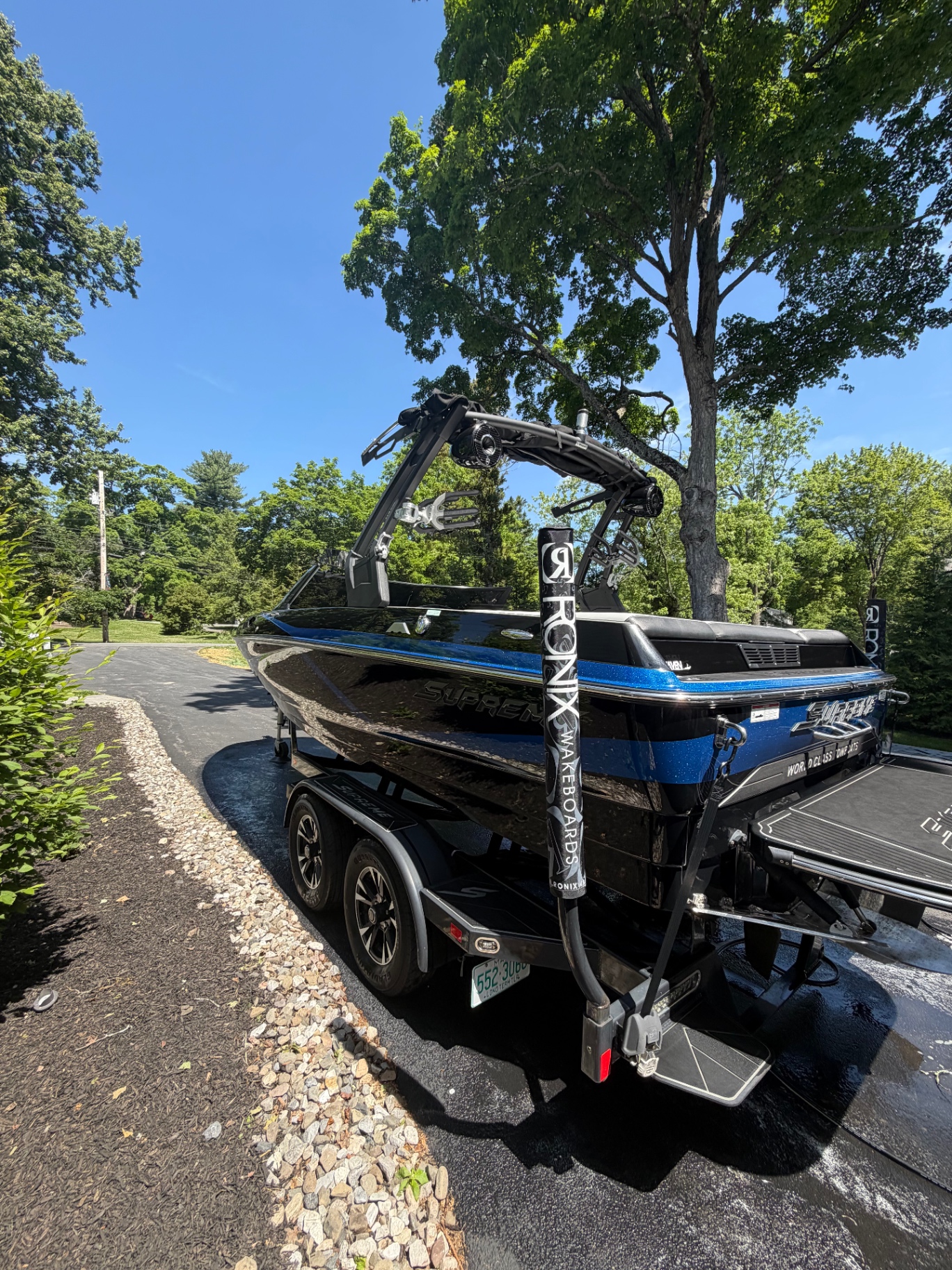 Rear view of a detailed wakeboard boat with glossy hull