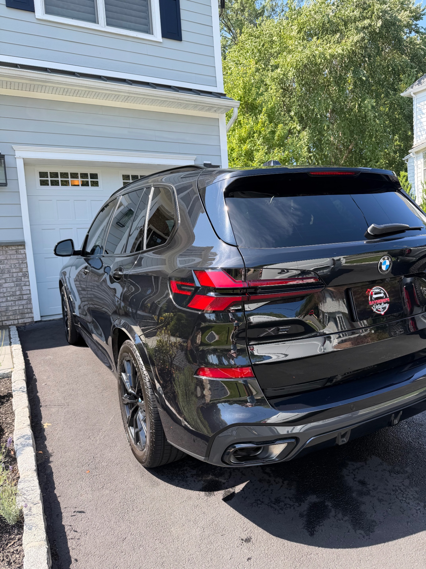 Black BMW X5 detailed to a mirror gloss in a driveway