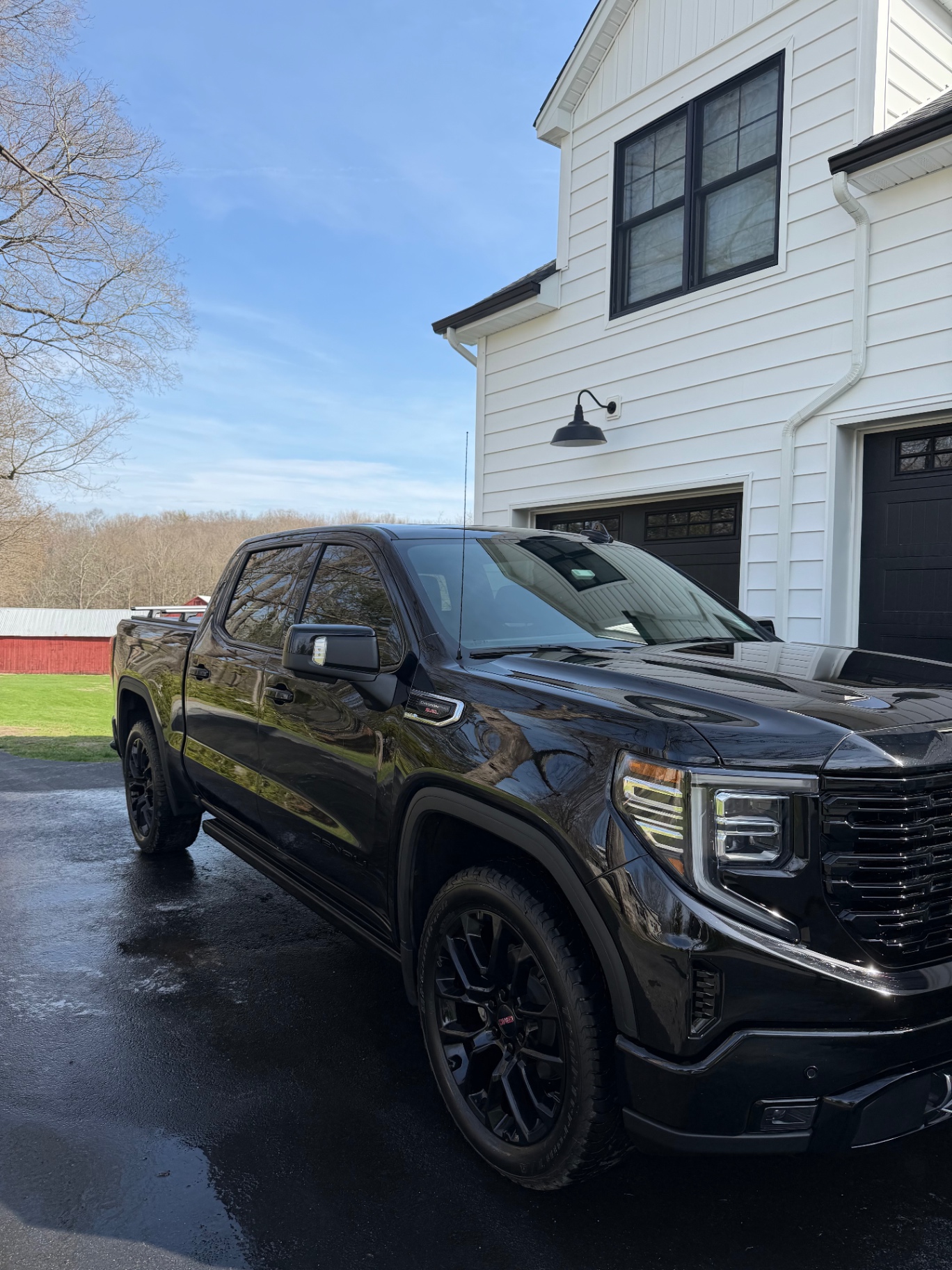 Black GMC Sierra with mirror-gloss paint after a full detail